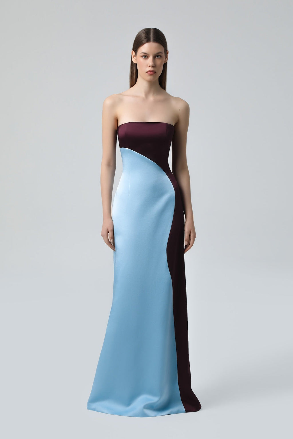Model wearing NDS The Label two-toned strapless satin maxi dress in blue and wine.